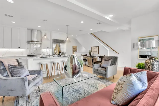 a living room with furniture a fireplace and a table