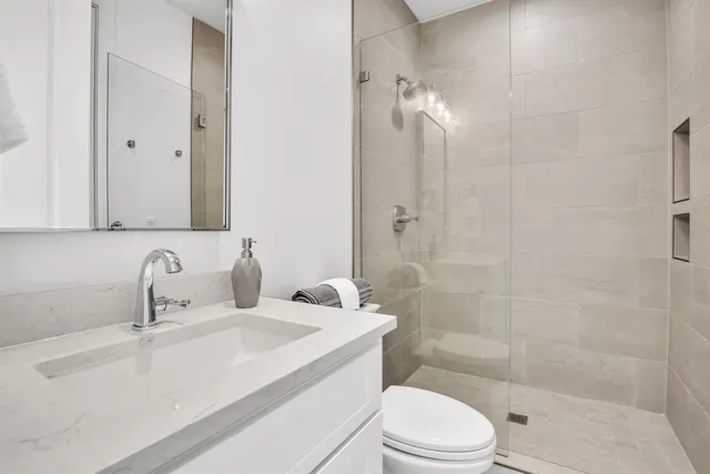 a bed room with a bed and a chair