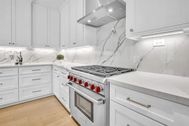 a kitchen with granite countertop a stove and a sink