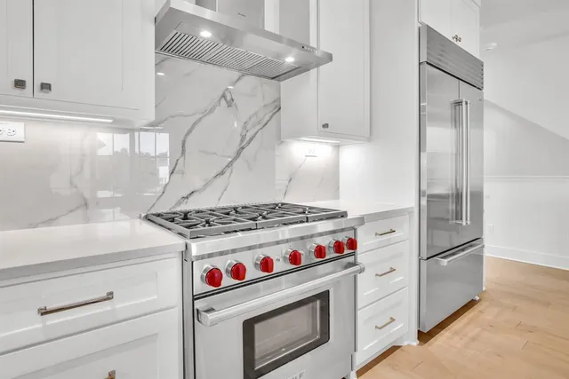 a kitchen with a stove and a refrigerator