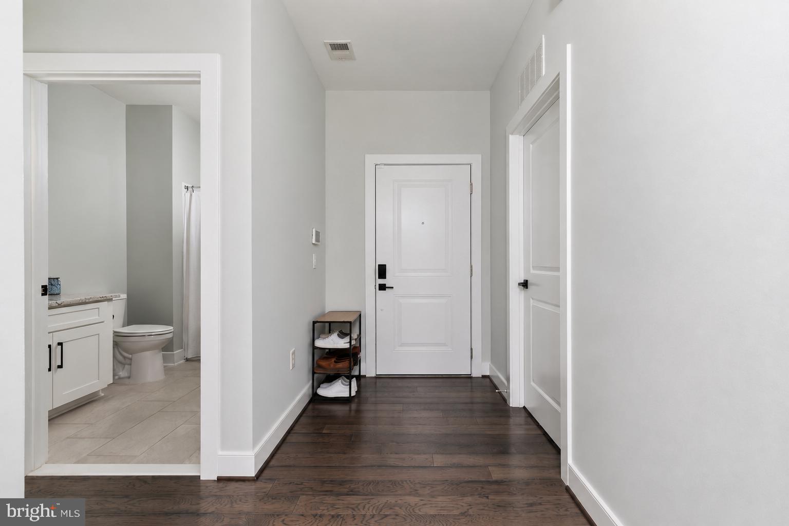 11200 Reston Station Boulevard, Unit 208 Reston, VA 20190 - Photo 5 of 61 Wide unit entrance with high ceilings