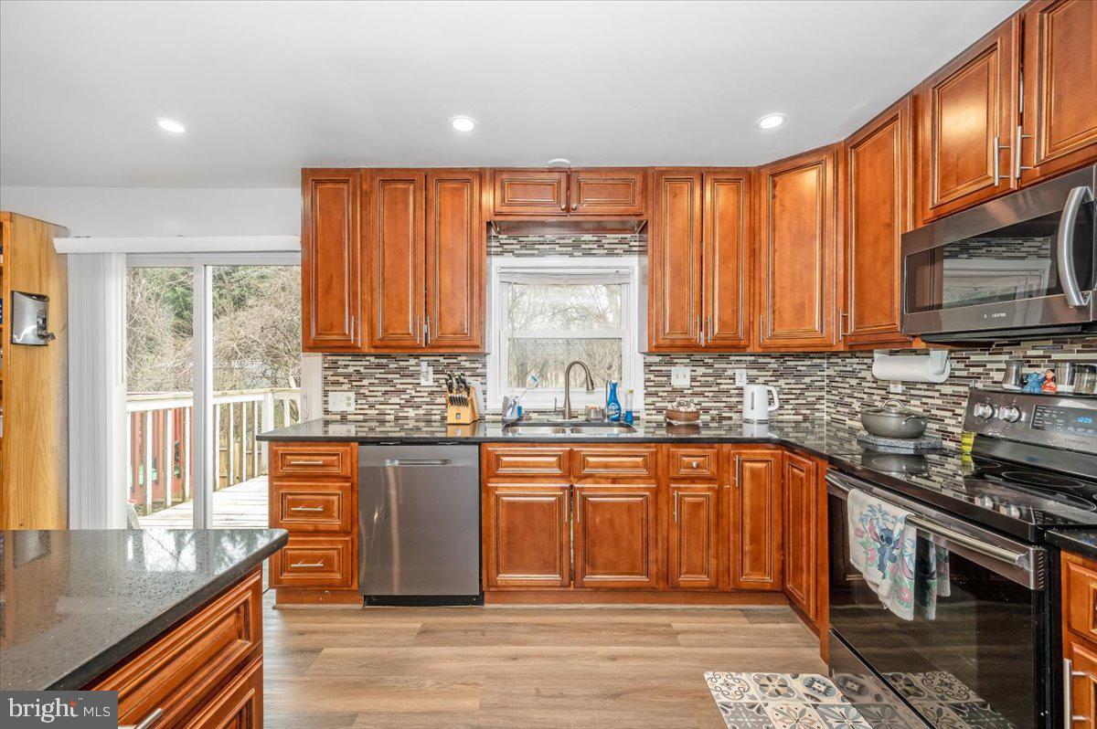 1864 Murdock Court Frederick, MD 21702 - Photo 11 of 39 a kitchen with stainless steel appliances granite countertop sink stove top oven and cabinets