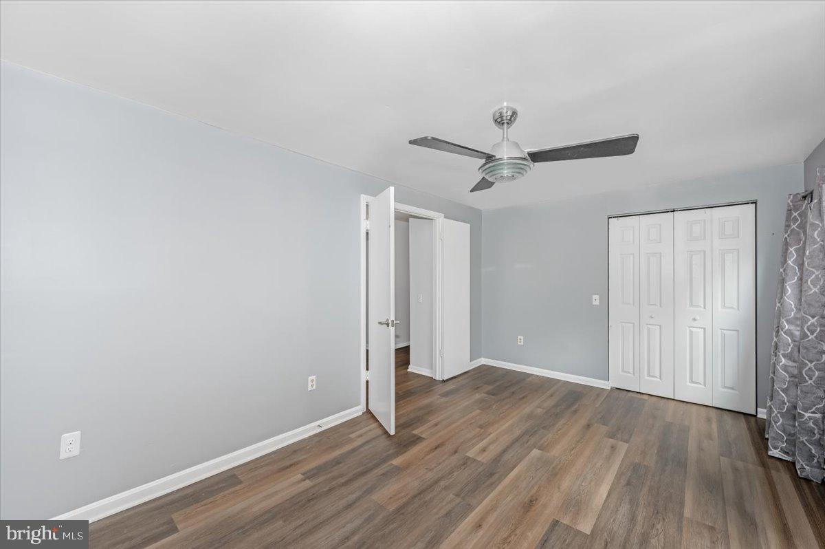 1864 Murdock Court Frederick, MD 21702 - Photo 17 of 39 an empty room with wooden floor and a ceiling fan