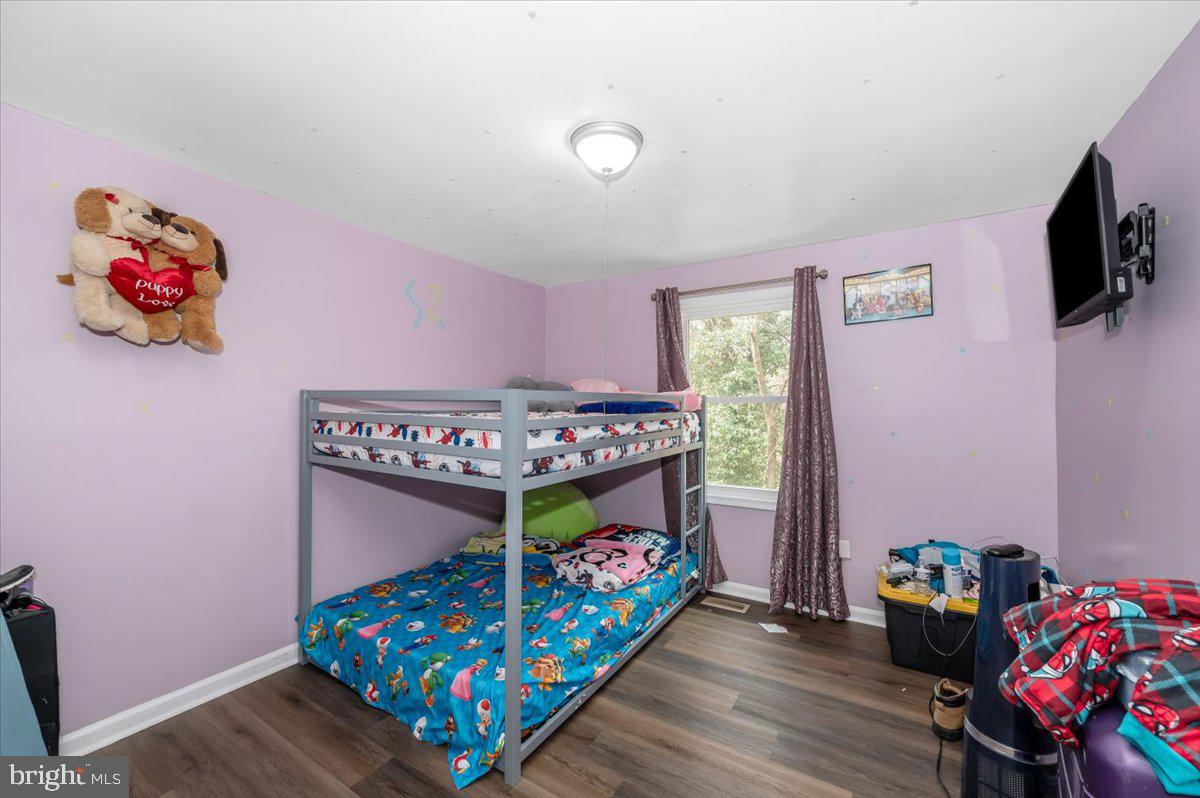 1864 Murdock Court Frederick, MD 21702 - Photo 20 of 39 a bedroom with bed and a wooden floor