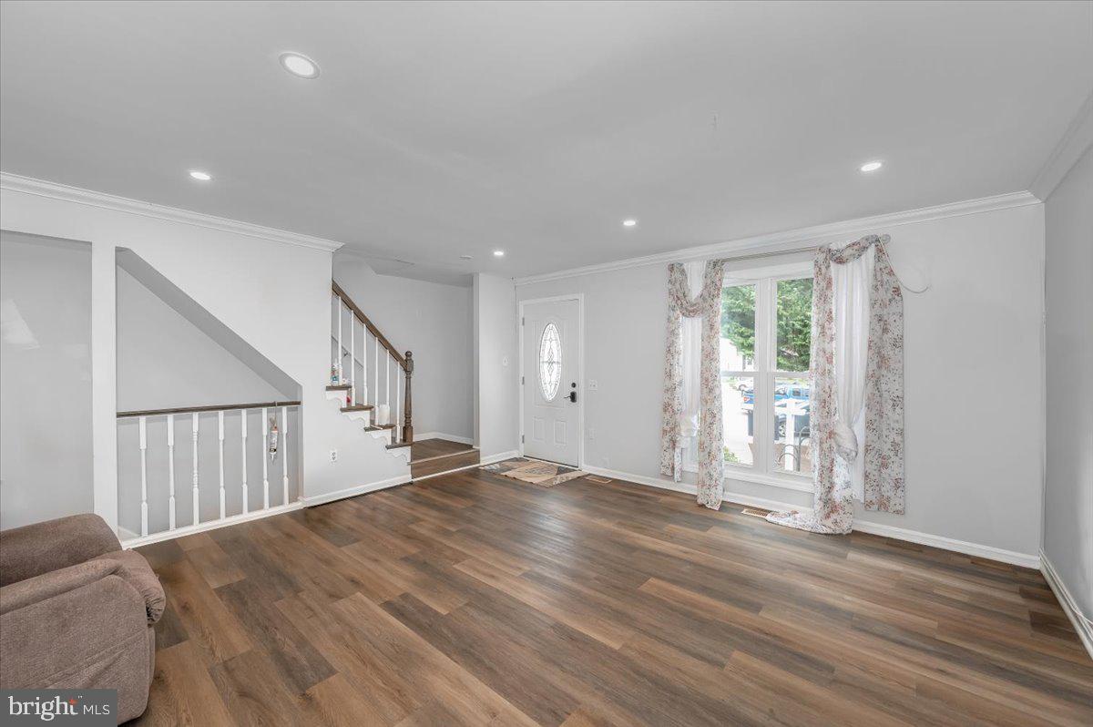 1864 Murdock Court Frederick, MD 21702 - Photo 2 of 39 a view of an empty room with wooden floor and a window