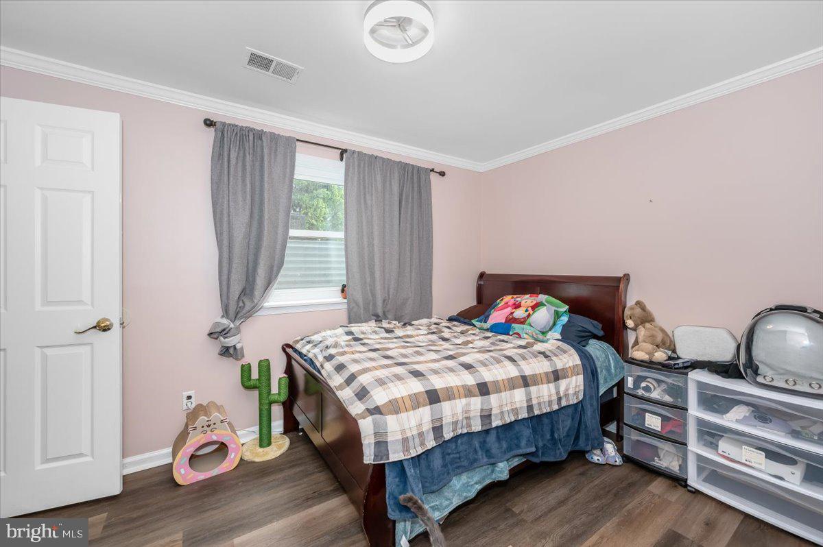 1864 Murdock Court Frederick, MD 21702 - Photo 25 of 39 a bedroom with a bed and wooden floor