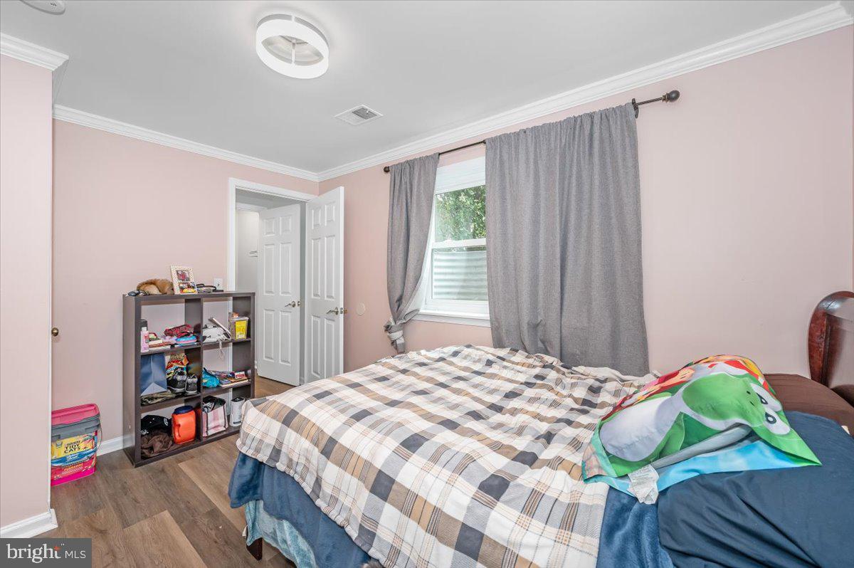 1864 Murdock Court Frederick, MD 21702 - Photo 26 of 39 a bedroom with a bed and a wooden floor