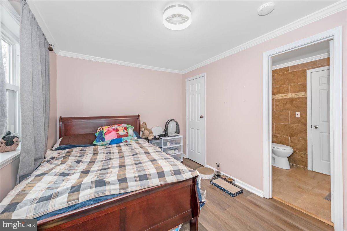 1864 Murdock Court Frederick, MD 21702 - Photo 27 of 39 a bedroom with a bed and wooden floor