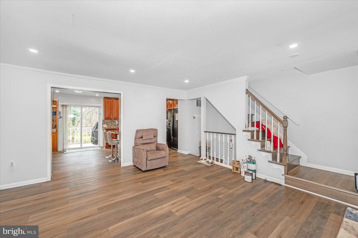 1864 Murdock Court Frederick, MD 21702 - Photo 4 of 39 a view of an empty room with wooden floor and stairs