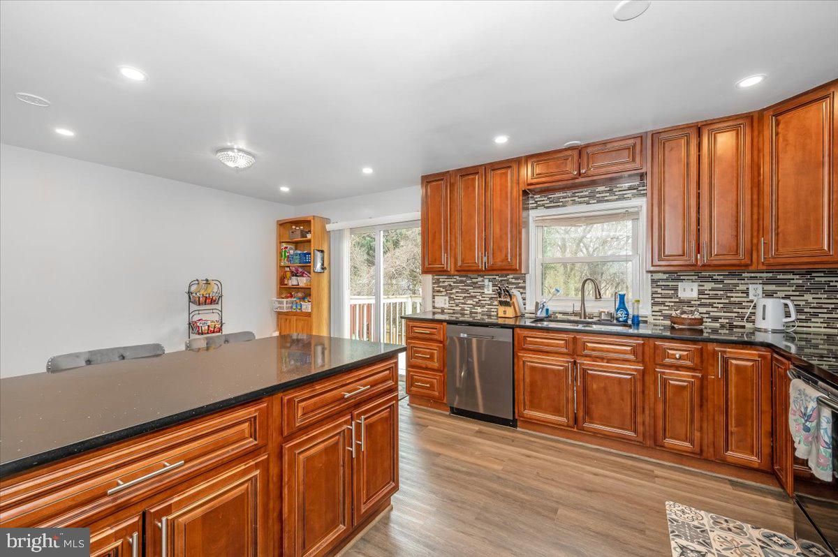 1864 Murdock Court Frederick, MD 21702 - Photo 10 of 39 a kitchen with stainless steel appliances granite countertop wooden cabinets a sink and dishwasher a oven with wooden floor