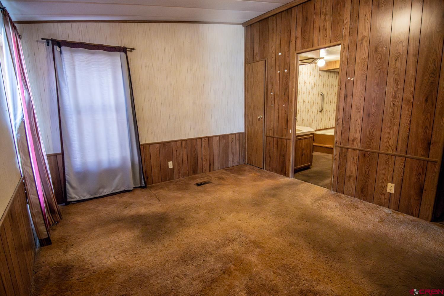 17240 Rd G Cortez, CO 81321 - Photo 18 of 37 a view of an empty room with wooden door