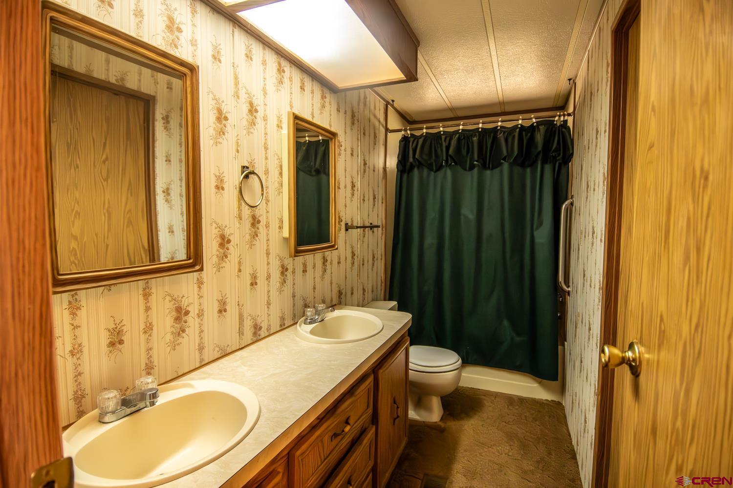 17240 Rd G Cortez, CO 81321 - Photo 22 of 37 a bathroom with a granite countertop sink toilet and shower