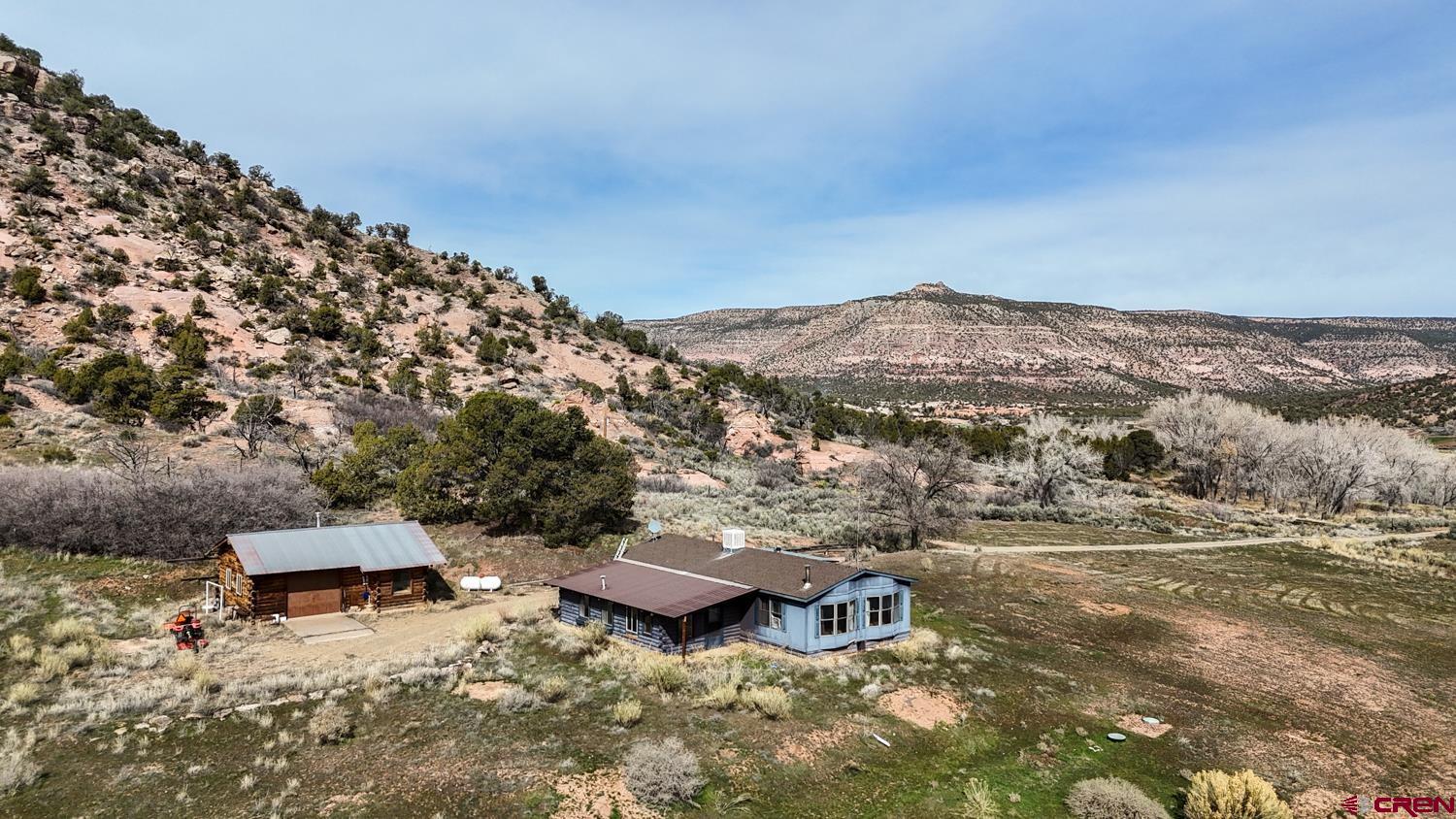 17240 Rd G Cortez, CO 81321 - Photo 6 of 37 an aerial view of a house with a yard and mountain view in back