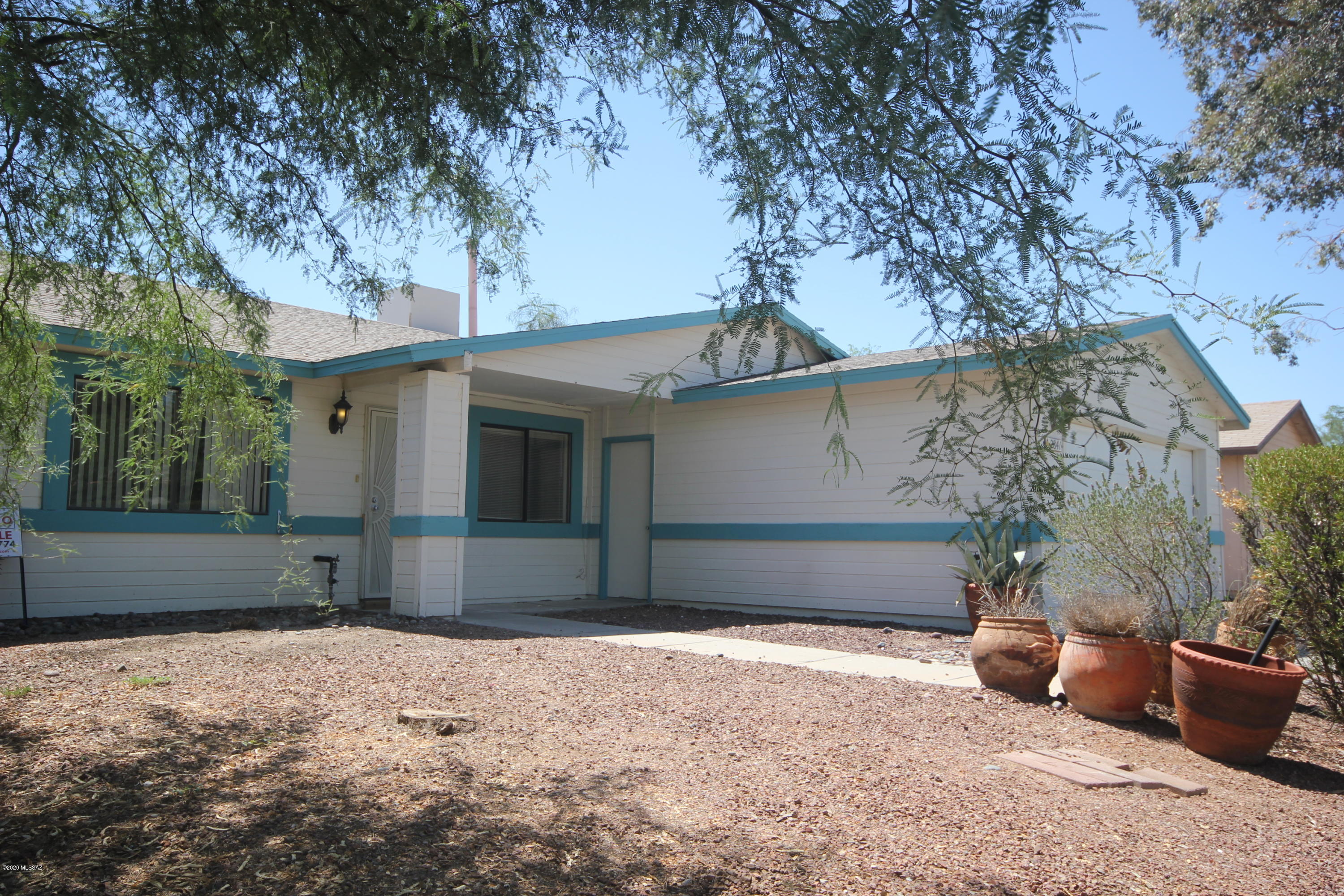 2841 West Firebrook Road Tucson, AZ 85741 - Photo 1 of 15 a front view of a house with a yard and garage