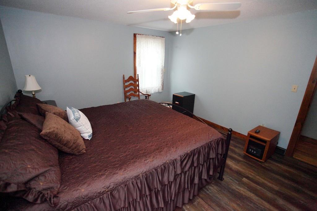 298 Mill Road Fairhaven, MA 02719 - Photo 23 of 39 a bedroom with a bed and wooden floor