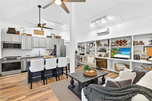a living room with lots of furniture and kitchen view
