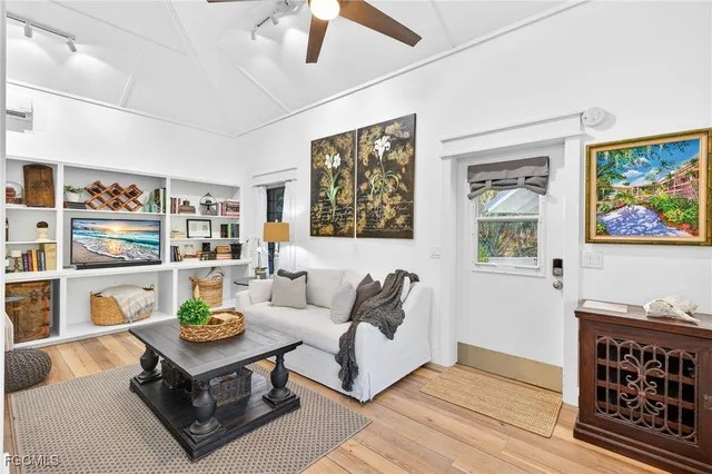 a living room with furniture and painting on the wall