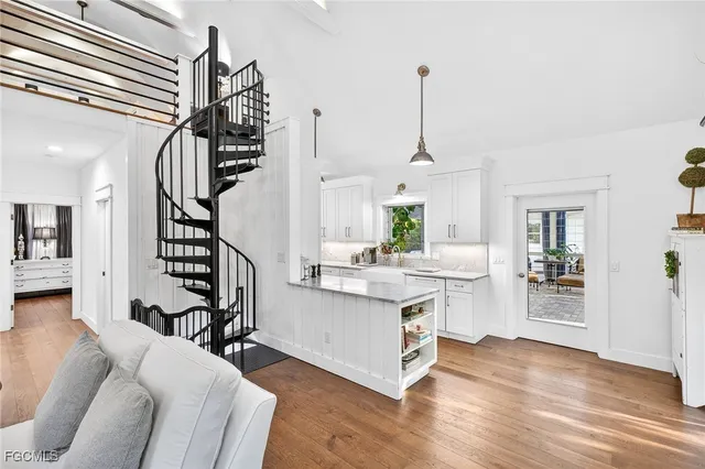 a kitchen with kitchen island stainless steel appliances a stove and wooden floor