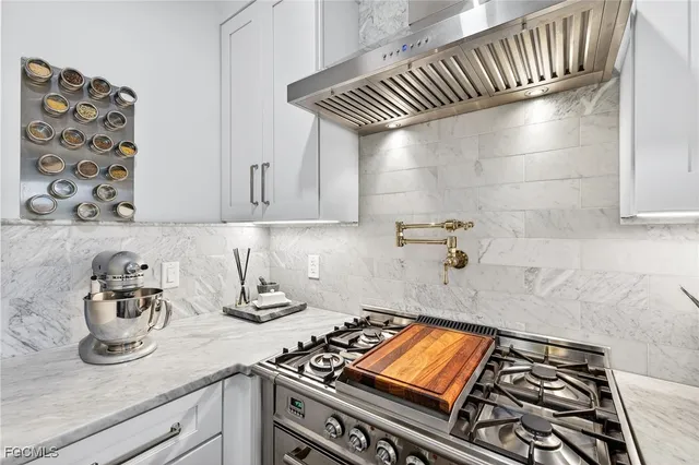 a kitchen with stove and cabinets