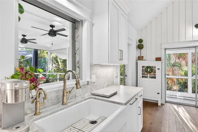 a kitchen with a sink a stove and a window