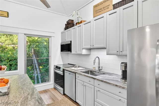 a kitchen with stainless steel appliances granite countertop a refrigerator and a sink