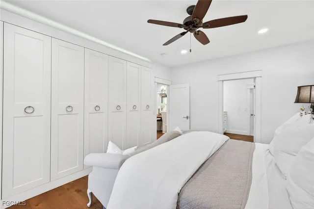 a bedroom with a bed ceiling fan and a window