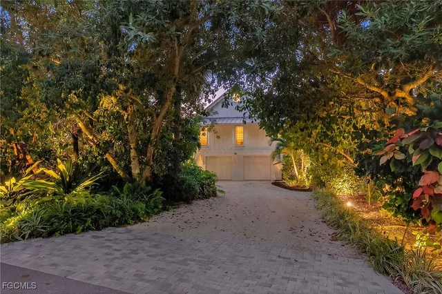 a pathway of a house with yard and tree s