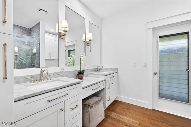 a spacious bathroom with a granite countertop sink and a mirror