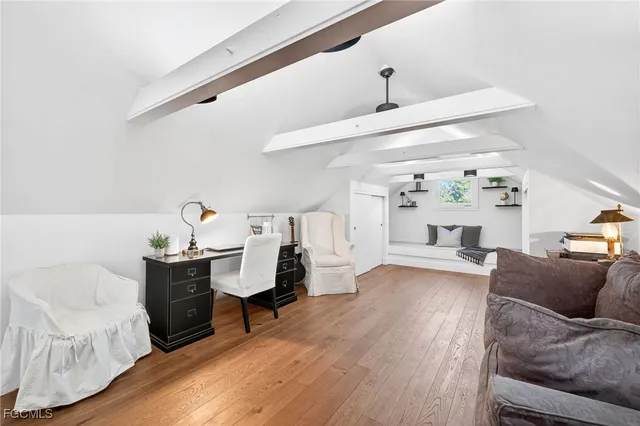 a living room with a couch and a wooden floor