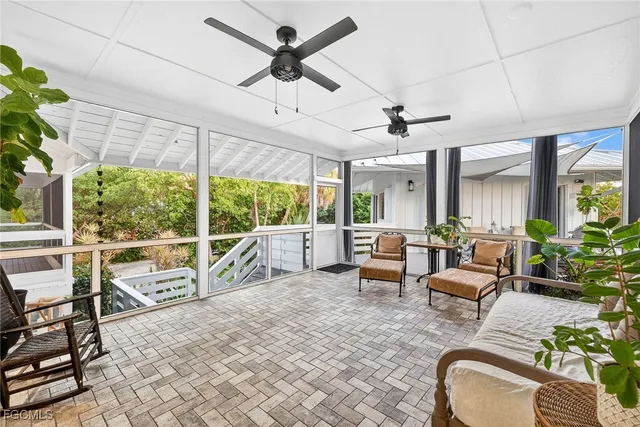 a living room with furniture and a floor to ceiling window