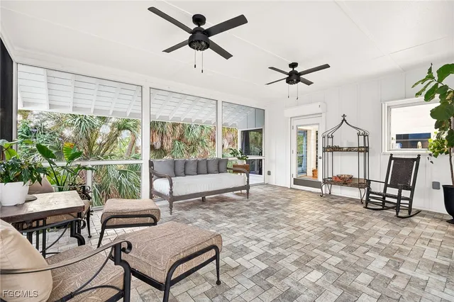 a view of an house with wooden deck and floor to ceiling window