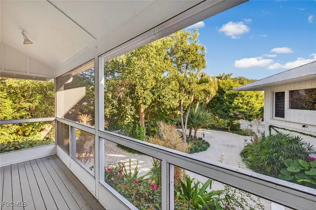a front view of a house with garden and plants