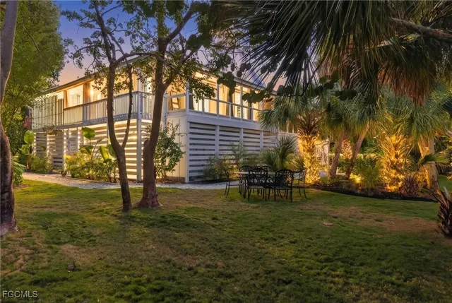 a view of a house with backyard and sitting area