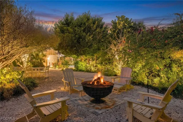 a view of a backyard with plants and outdoor seating