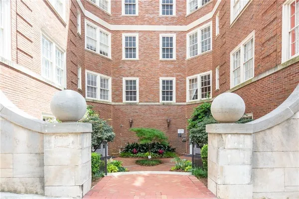 a front view of a multi story residential apartment building with a yard