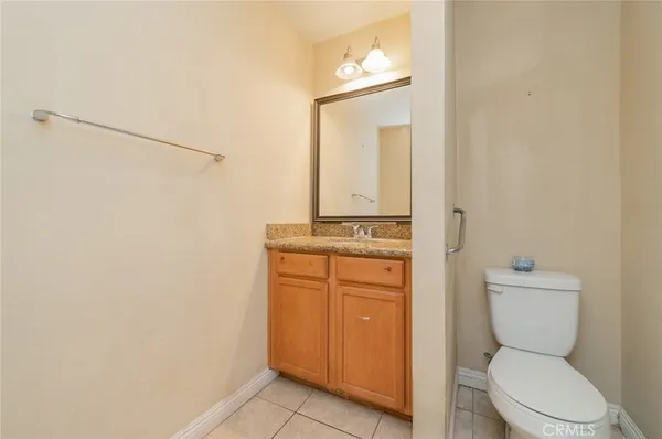 a bathroom with a toilet a sink and a mirror