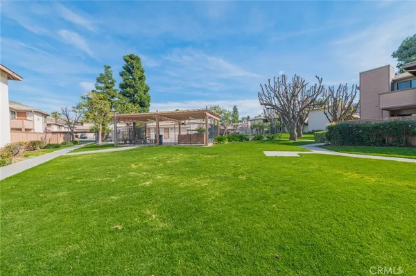 a view of a house with a big yard and large trees