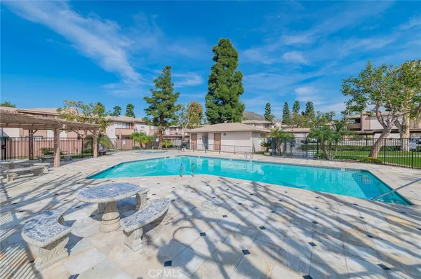 a view of swimming pool with outdoor seating and city view