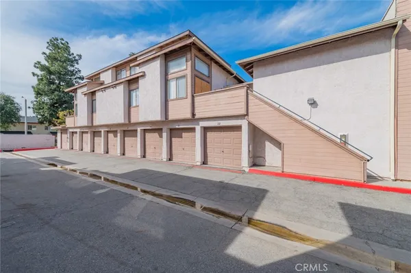 a front view of a house with a road