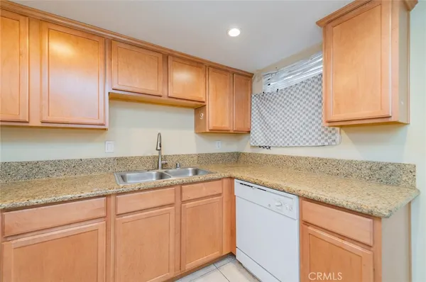a kitchen with a sink cabinets and window