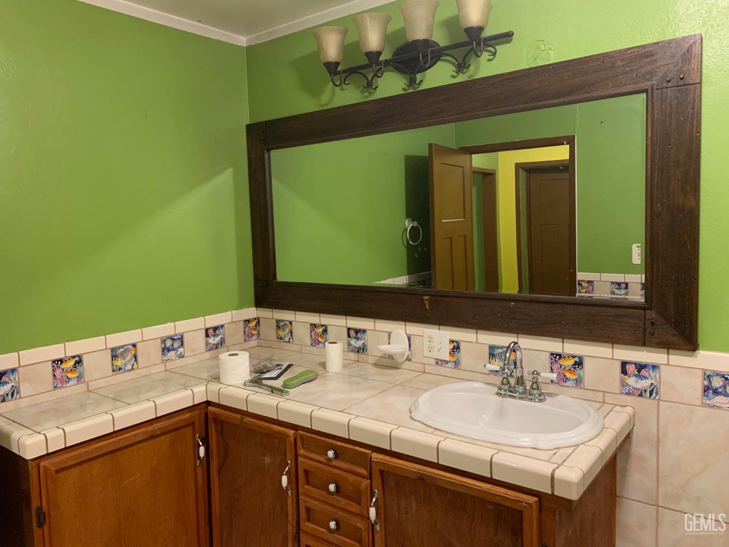 Undisclosed Address Lamont, CA 93241 - Photo 7 of 10 a bathroom with a sink and a mirror