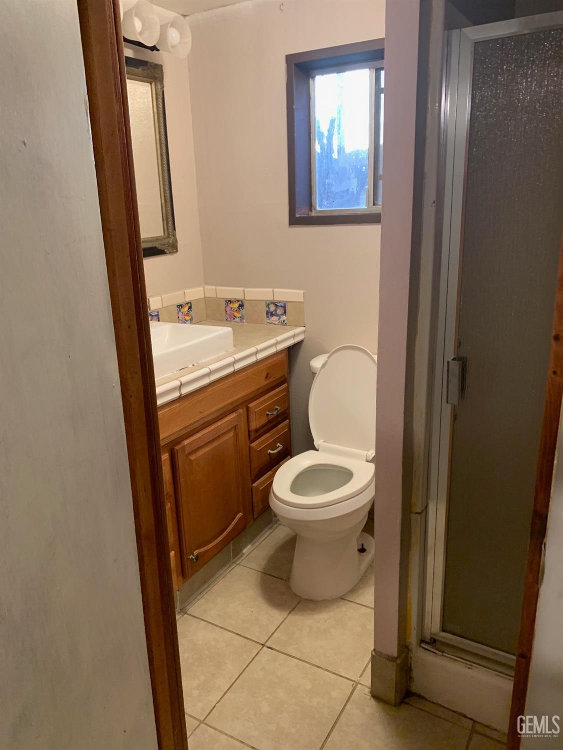 Undisclosed Address Lamont, CA 93241 - Photo 9 of 10 a bathroom with a toilet a sink and a mirror