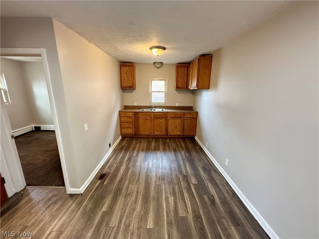 4652 Warner Road, Unit 3 Cleveland, OH 44125 - Photo 7 of 13 Kitchen featuring wood finish cabinetry and dark wood finished floors