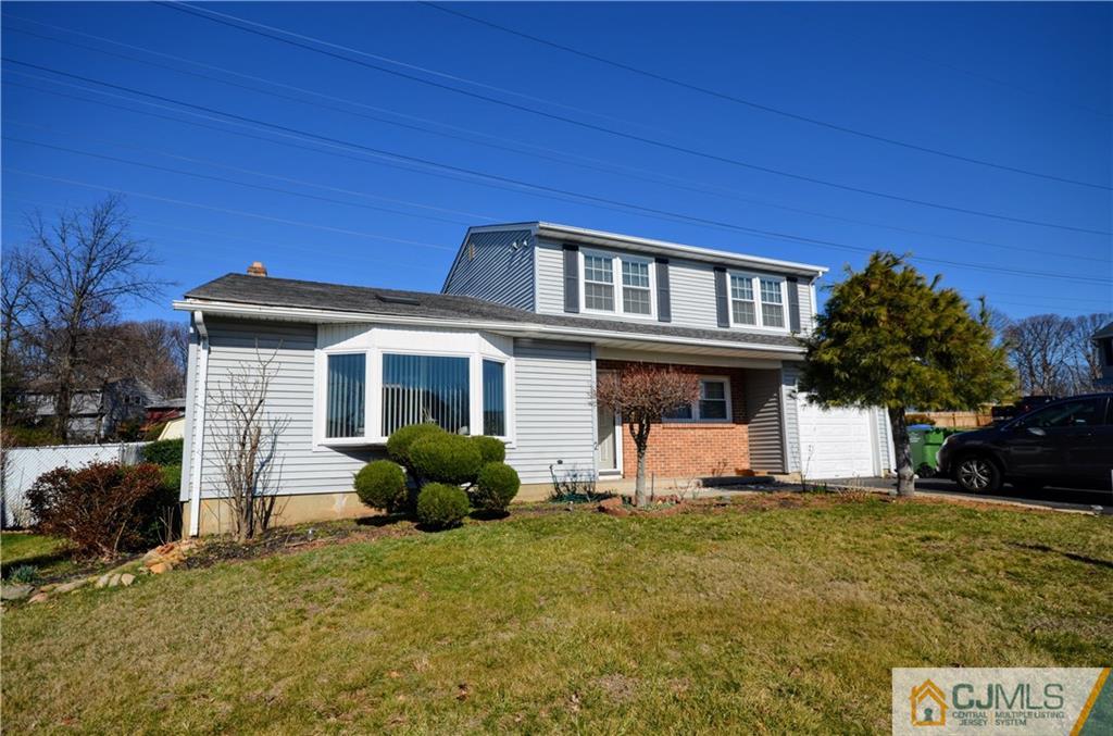 2 Ridge Road Edison, NJ 08817 - Photo 1 of 18 a front view of a house with garden