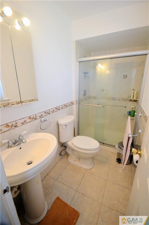 2 Ridge Road Edison, NJ 08817 - Photo 14 of 18 a bathroom with a sink a toilet and a mirror