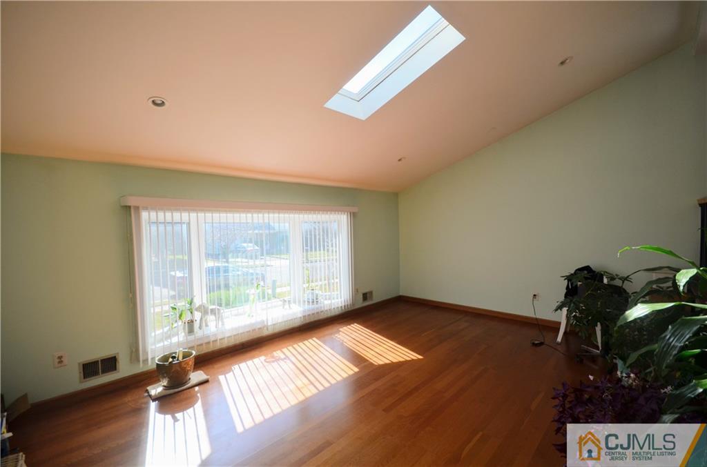 2 Ridge Road Edison, NJ 08817 - Photo 3 of 18 a view of an empty room with a window and wooden floor