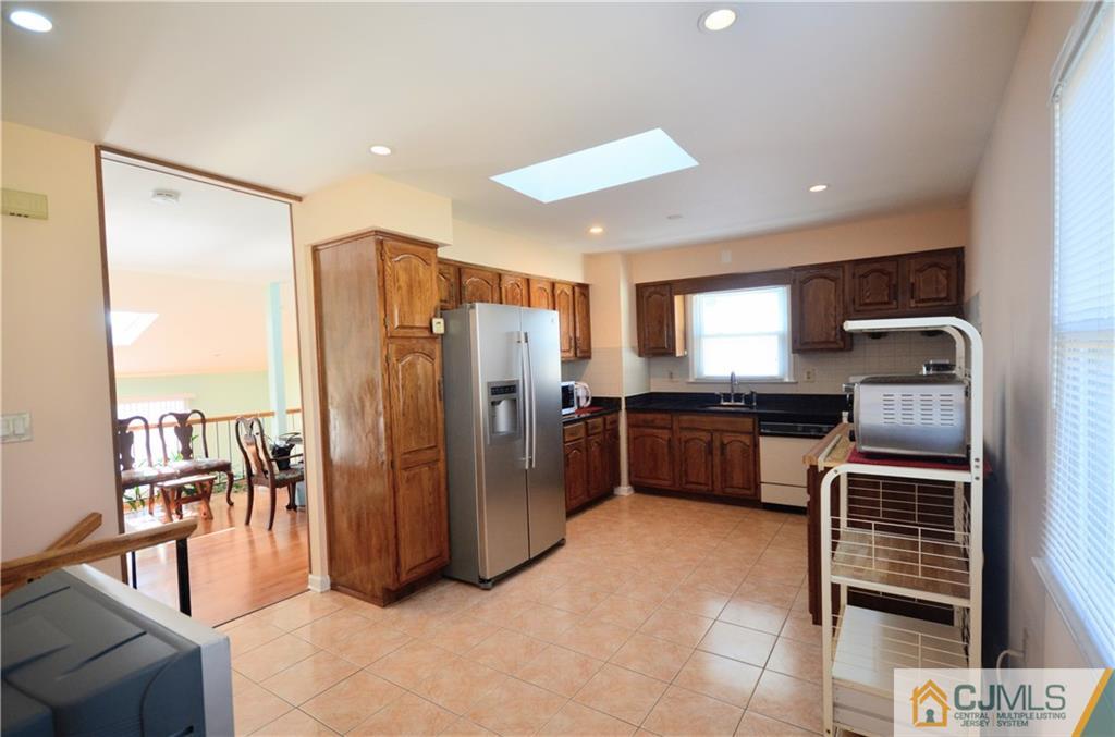 2 Ridge Road Edison, NJ 08817 - Photo 6 of 18 a kitchen with stainless steel appliances a refrigerator and a stove top oven