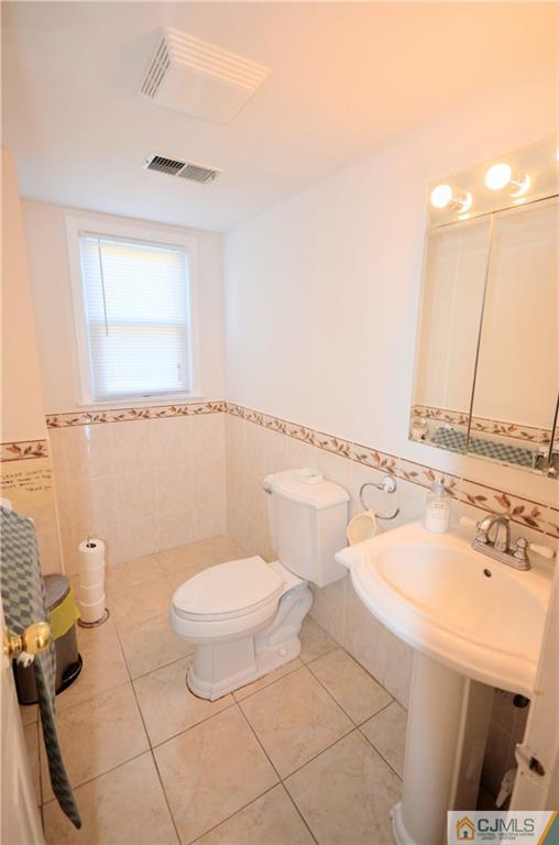 2 Ridge Road Edison, NJ 08817 - Photo 7 of 18 a bathroom with a sink a toilet and a mirror