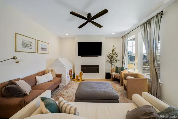a living room with furniture a fireplace and a flat screen tv