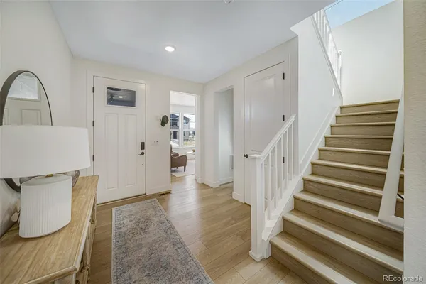 a view of entryway with wooden floor and stairs